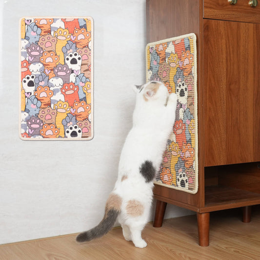 A cat using a colorful scratching mat with cartoon cat designs