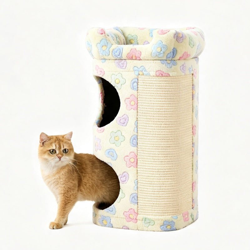 A ginger cat stands beside a cylindrical cat tower with a floral fabric cover and a sisal-wrapped scratching panel, photographed on a clean white background.