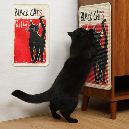 Black cat interacting with a 'Black Cats Rule' scratcher on a wooden cabinet.