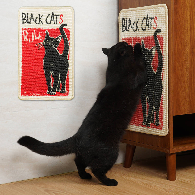 Black cat interacting with a 'Black Cats Rule' scratcher on a wooden cabinet.