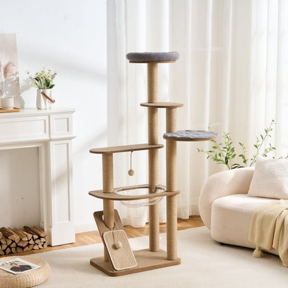 Real wood large cat tree in a white living room setting with a fireplace and sofa.