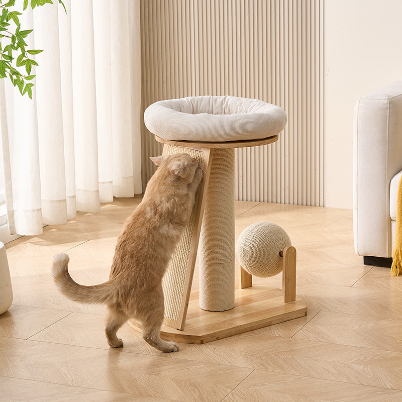 An orange cat is sharpening its claws on a sisal scratching pad on a wood cat tree.