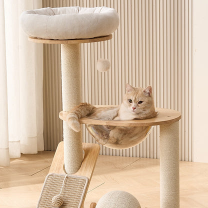 A light orange cat sleeping comfortablely in the space capsule cat bed of the white cat tree.