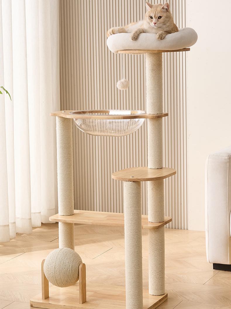 Cat tree with a cat perched on top in a room with light-colored walls and flooring.
