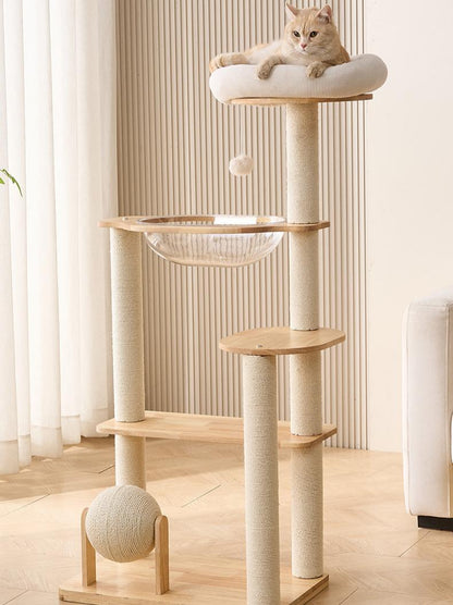 Cat tree with a cat perched on top in a room with light-colored walls and flooring.