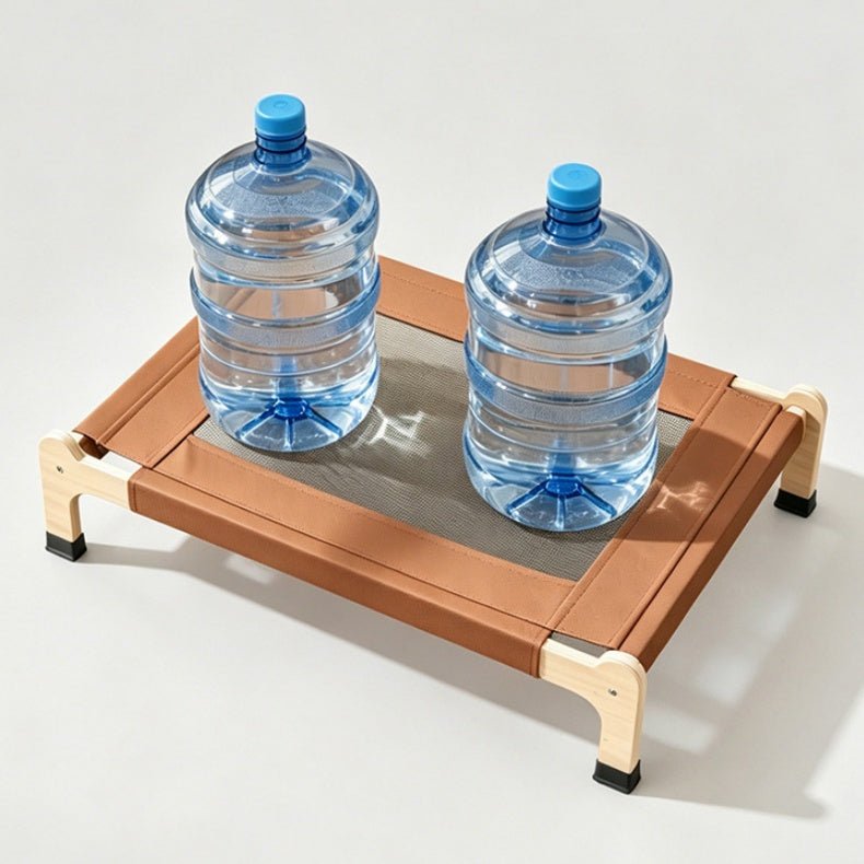 Two buckets of water are placed on a wooden elevated cat bed to demonstrate its weight-bearing capacity. The photo was taken against a simple, light gray studio backdrop.