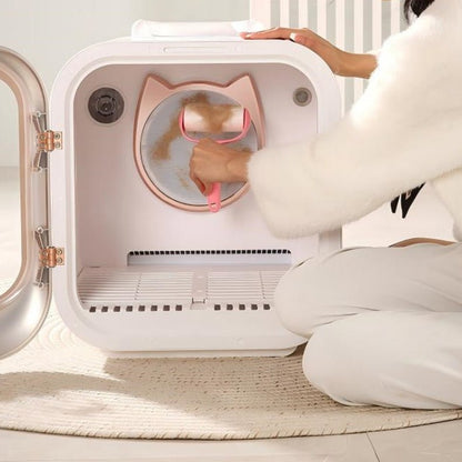 Person interacting with a smart pet dryer box on a light wooden floor.