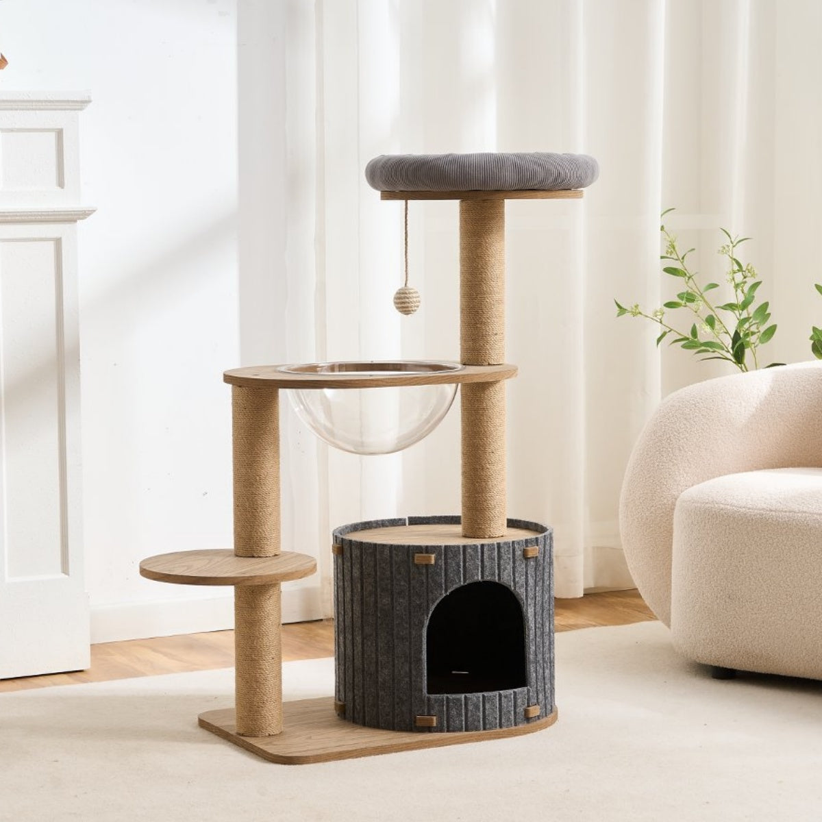 Wood Cat tree with multiple levels and a hideout space in a room with a white curtain and a plant.