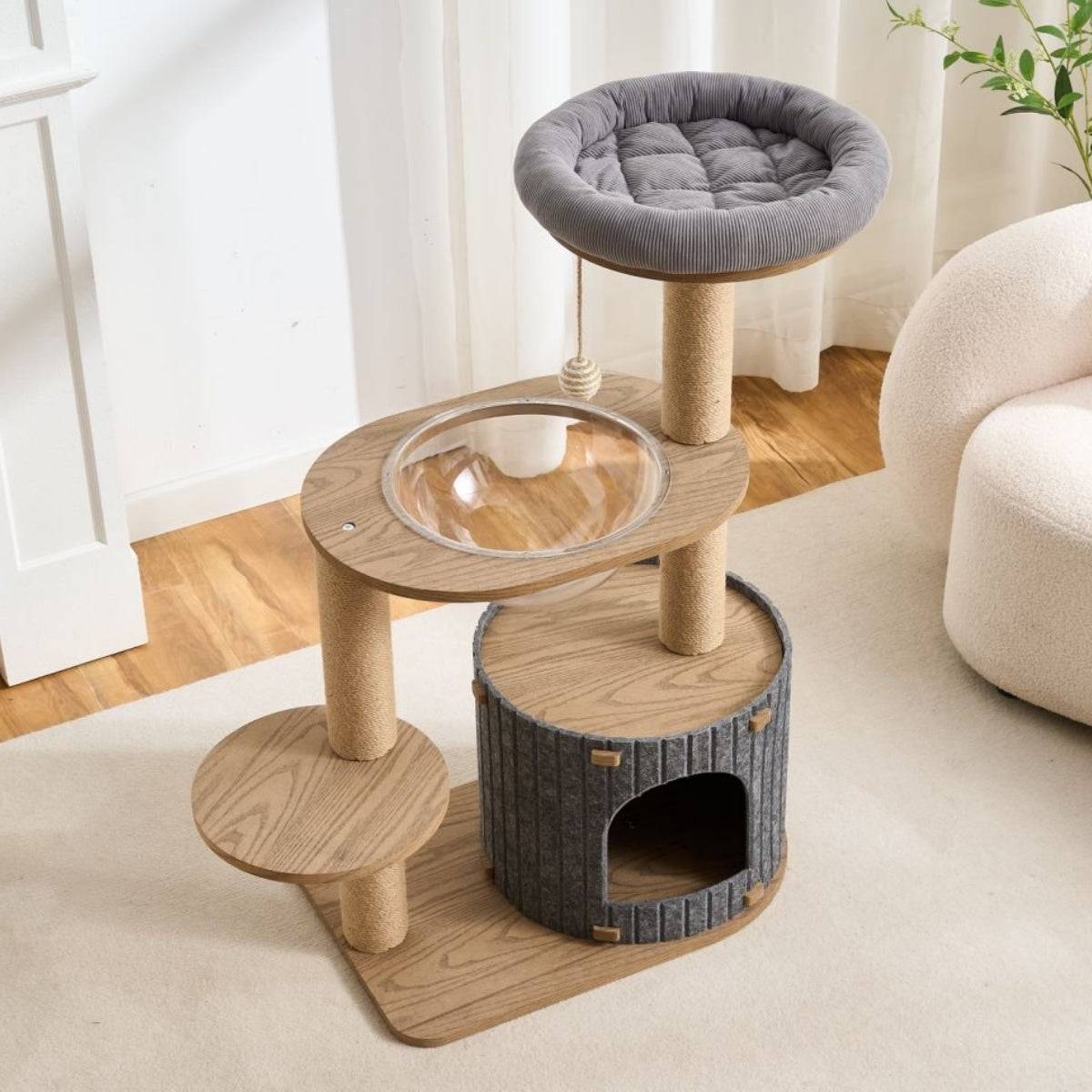Cat tree with multiple levels and a gray cat bed on a light-colored floor.