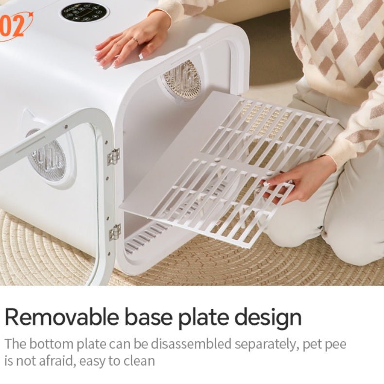 Person interacting with a pet dryer box, highlighting a removable base plate design.