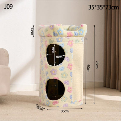 A large cat condo with dimensions labeled in a room setting. The product is cream-colored with pastel pink, blue, and yellow flower patterns on the top platform and sides, and a beige sisal-wrapped scratching panel.