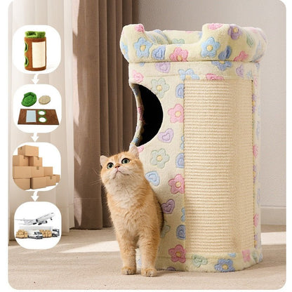 A fluffy orange cat stands beside a cylindrical cat condo in a home setting. The cat tree has a cream base with a pastel flower pattern in pink, blue, and yellow, plus a large woven scratching panel on the side.